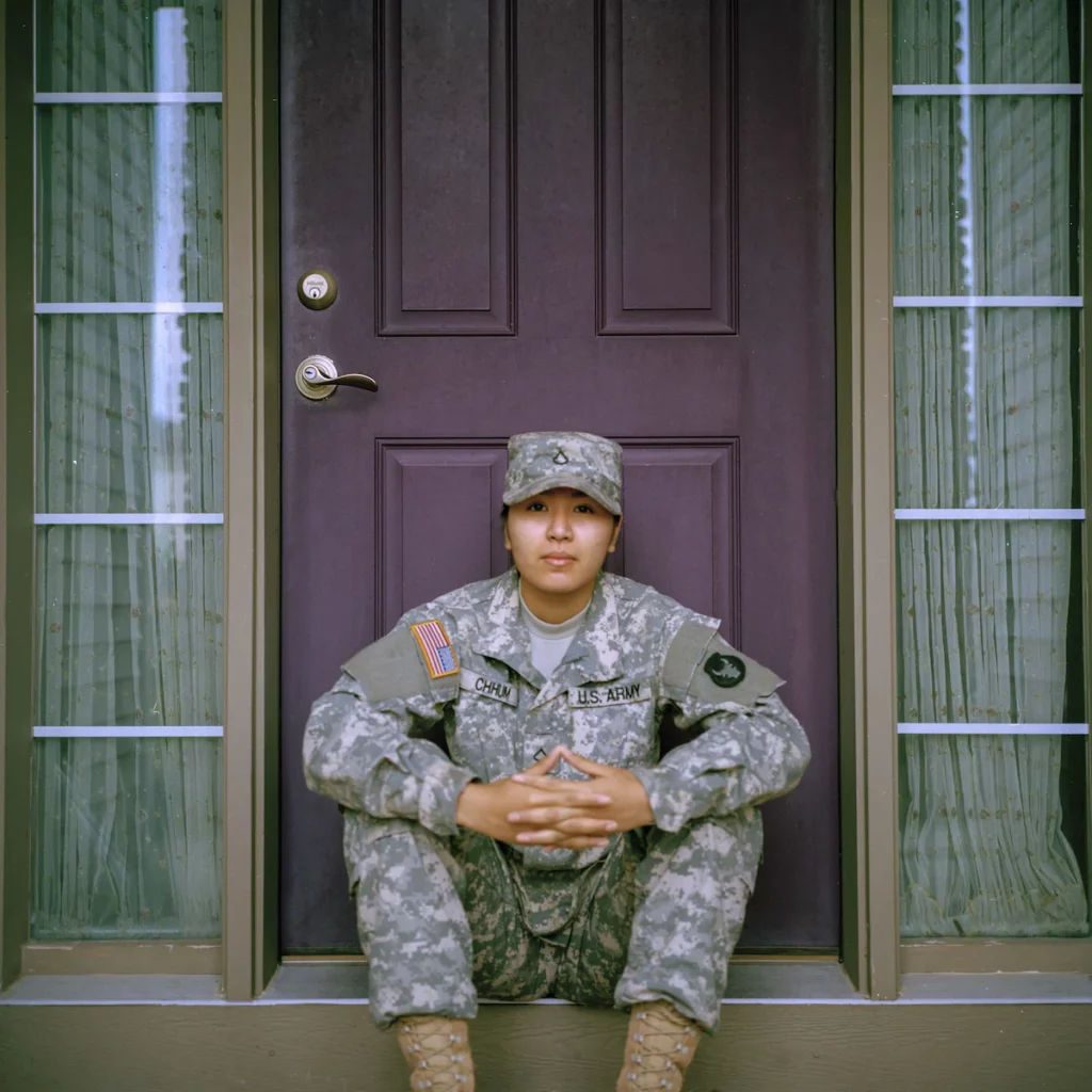 Armed forces career center: a military woman sitting in front of a closed door.